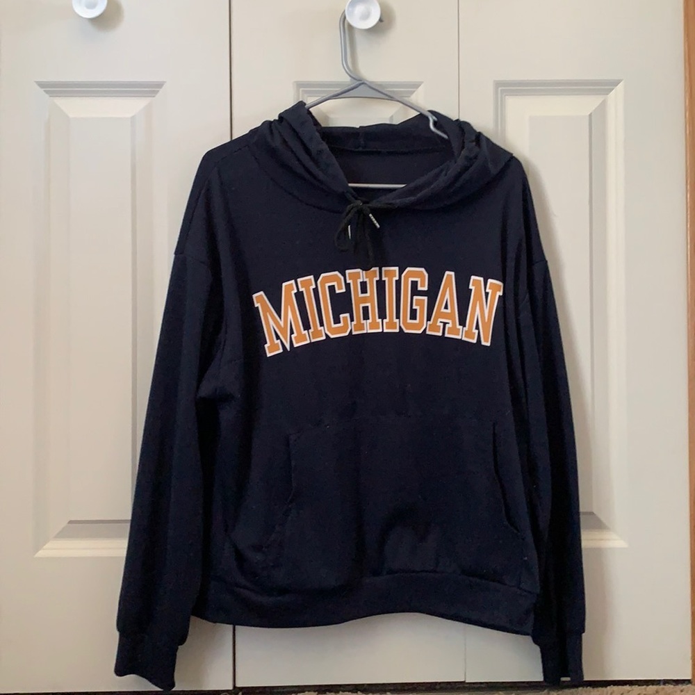 Michigan dark blue and orange writing hoodie.